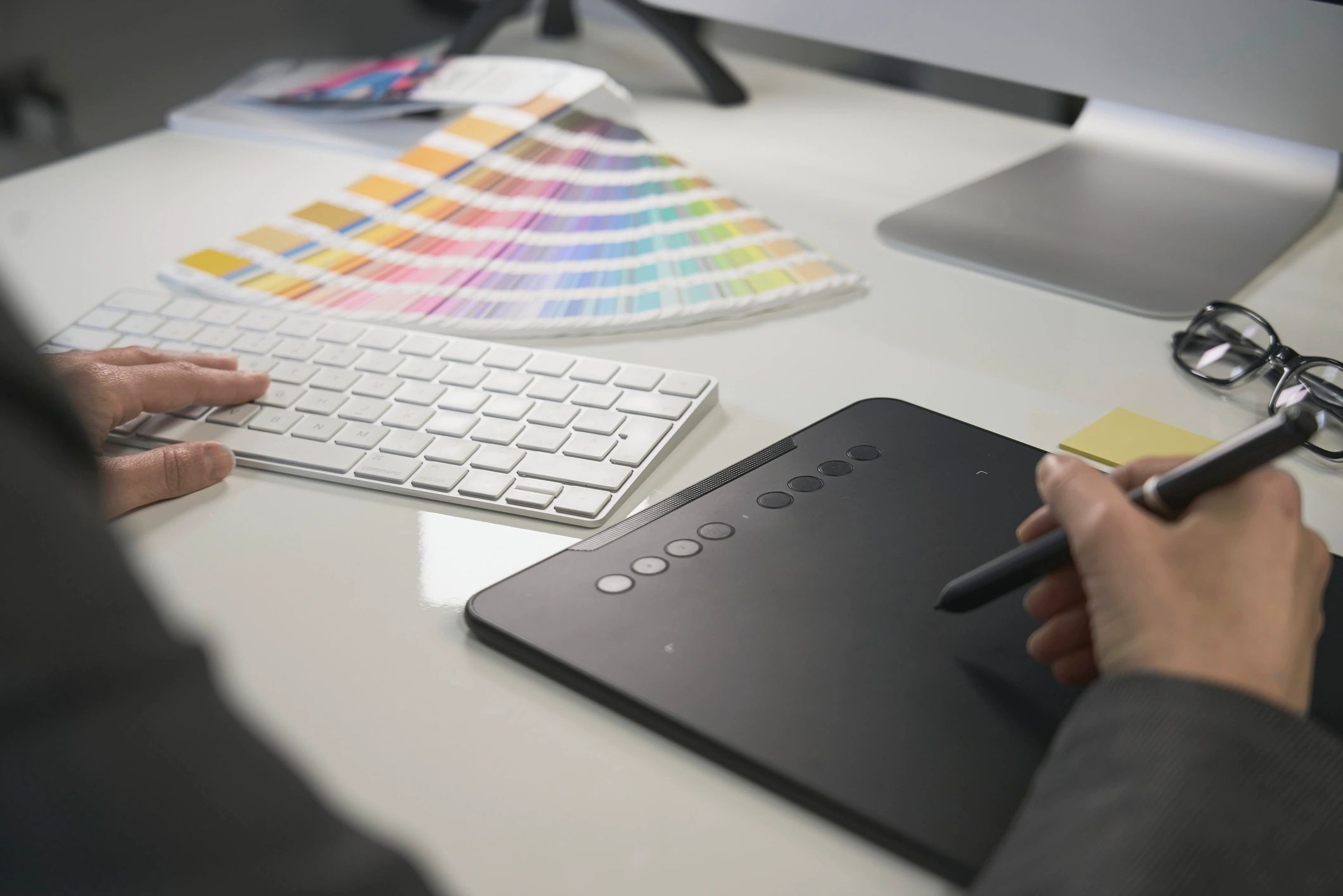 Designer selecting brand colors and working on digital brand assets