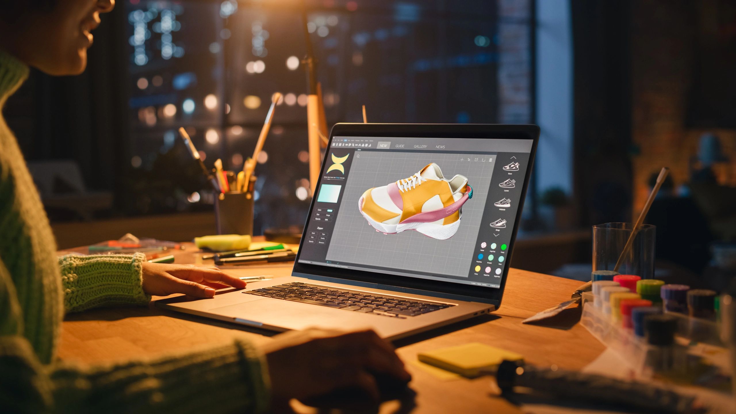 Designer working on digital brand assets on a laptop