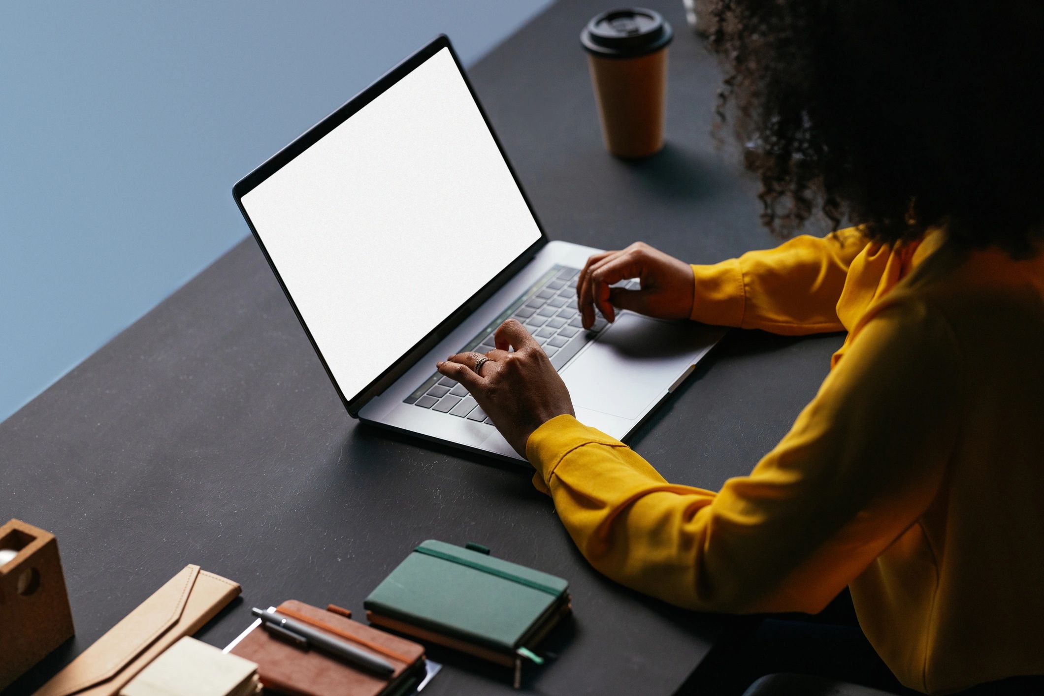 Person planning social media content on a laptop at a desk